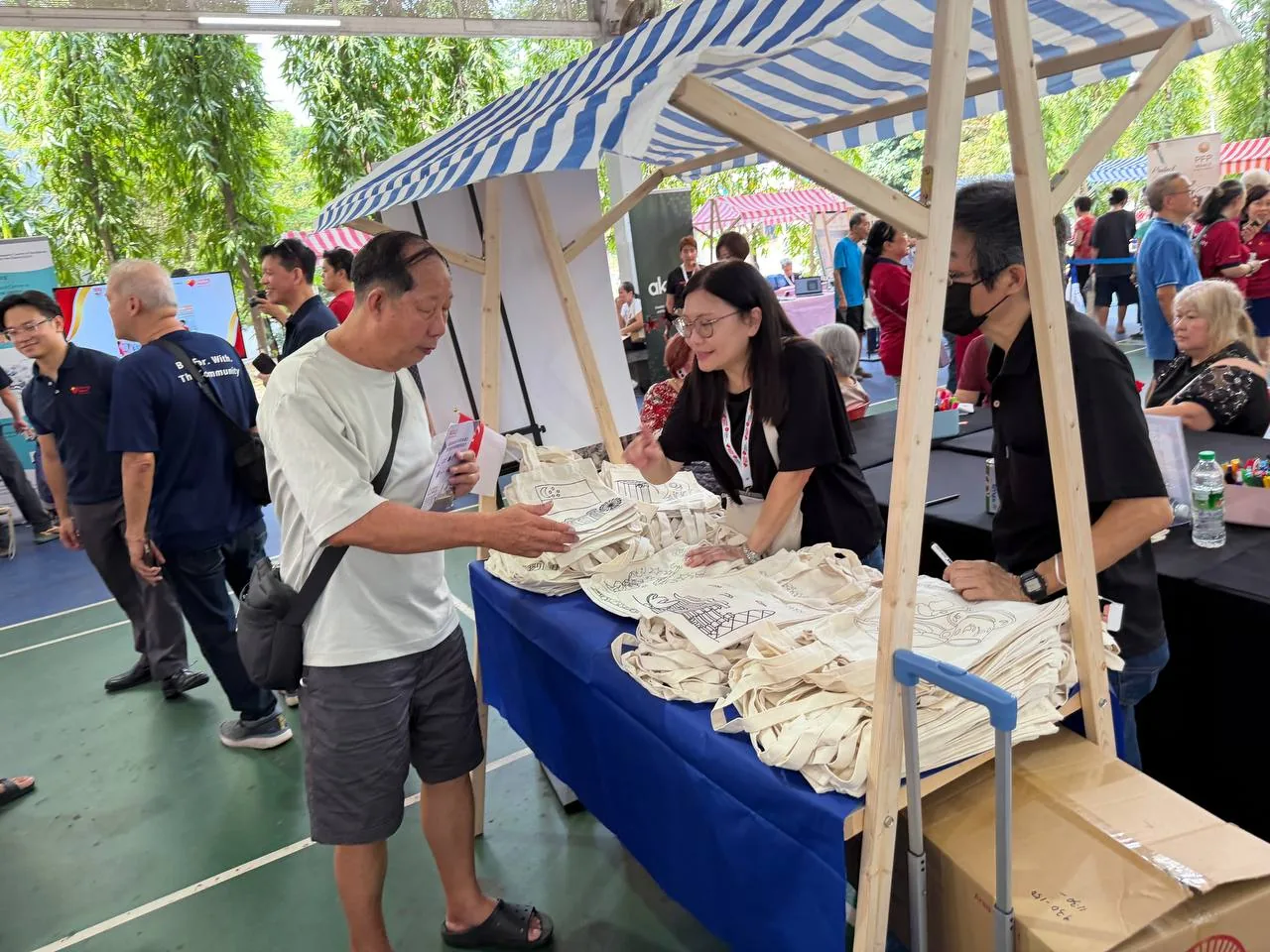 Volunteer at the Tou Hu game booth with participants