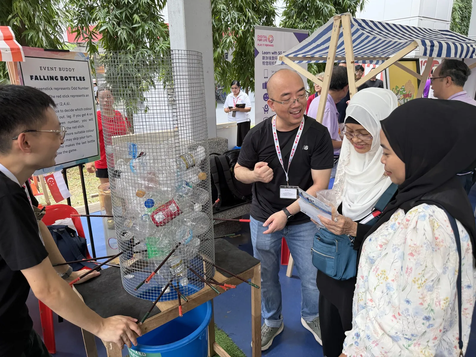 Volunteer explaining the Falling Bottles game