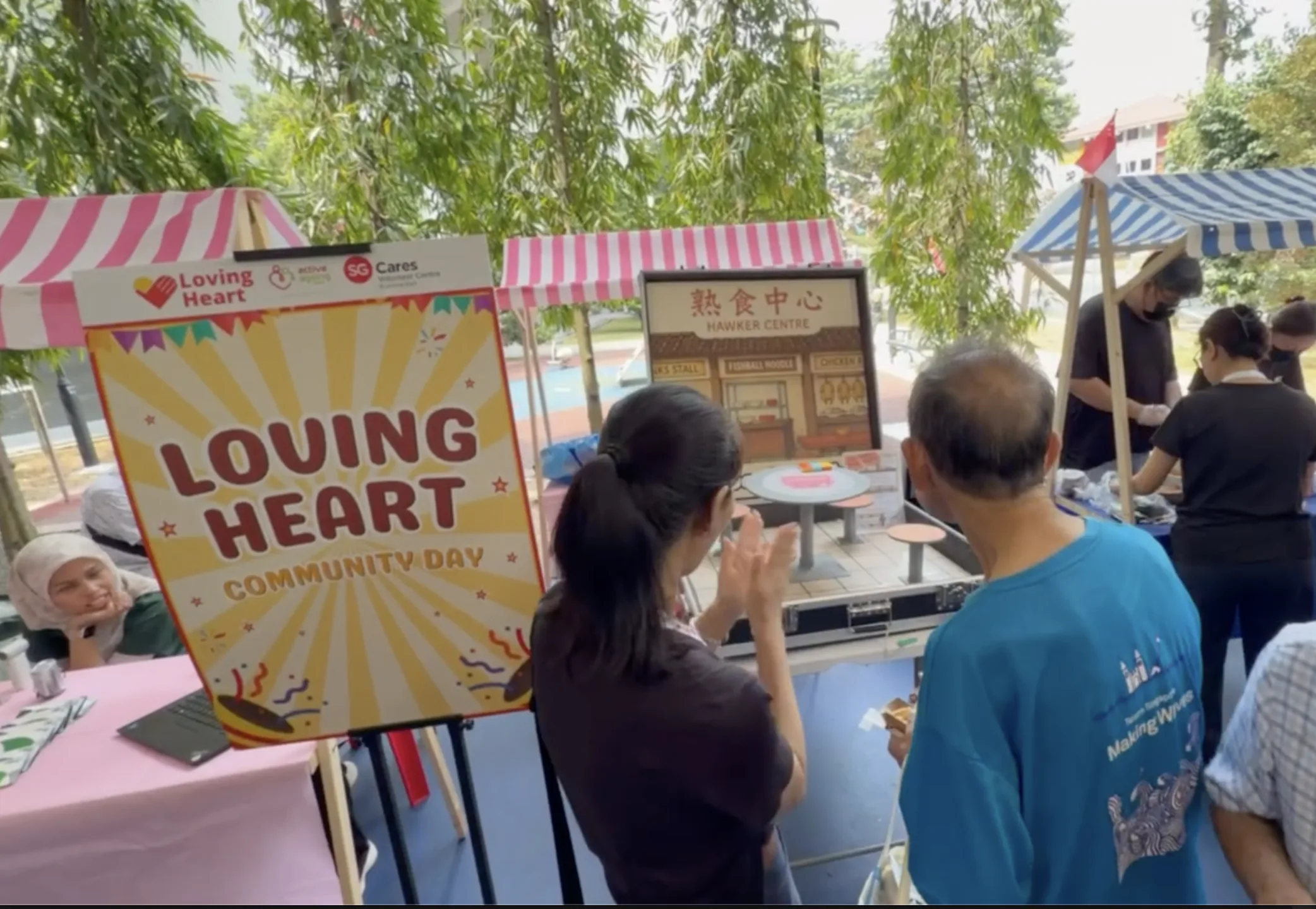 Volunteer at the Loving Heart Community Day activity booth